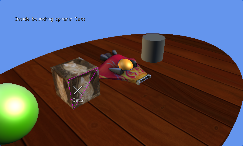 Four 3D models on a wooden table, with a triangle on the Cats box outlined in magenta.